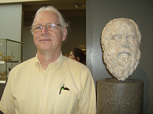 Dr. Fenton posing with a sculpture
