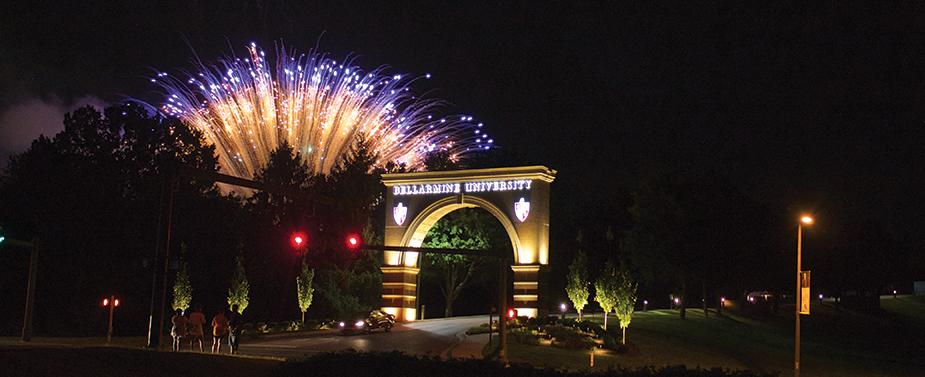 fireworks explode at night over bellarmine's arch