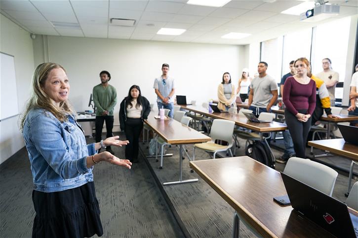 Students and a professor interacting in a Bellarmine University classroom.