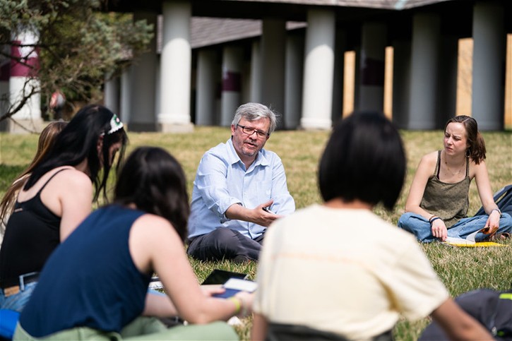 A Bellarmine University History class engages in discussion outside on the university quad.