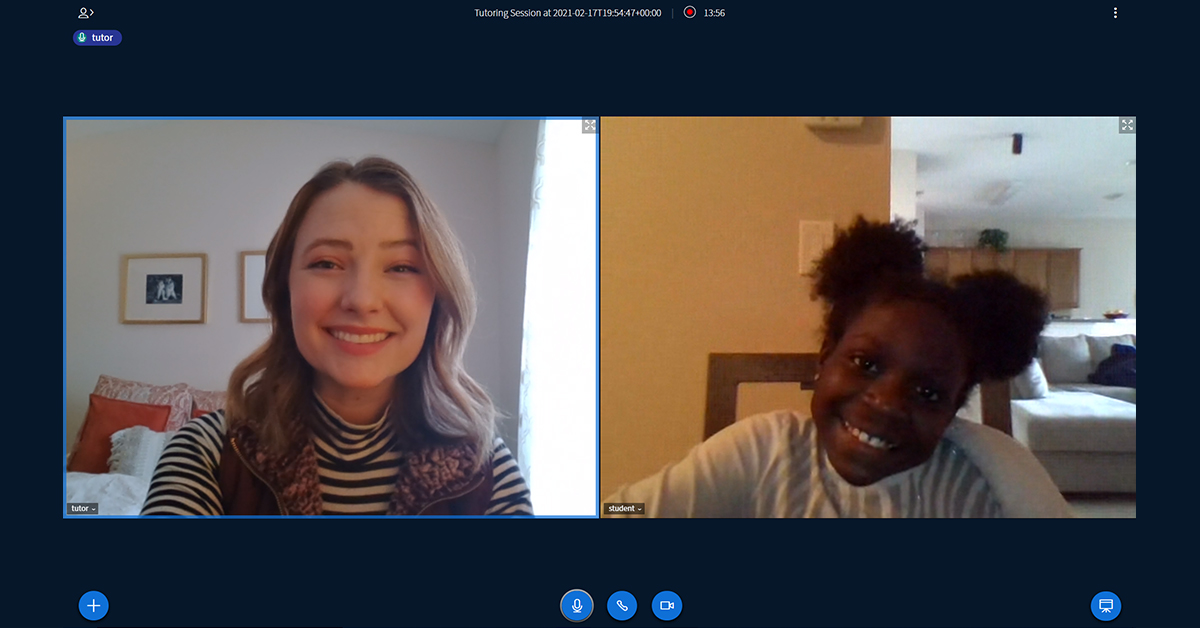 Two people on a virtual meeting smiling