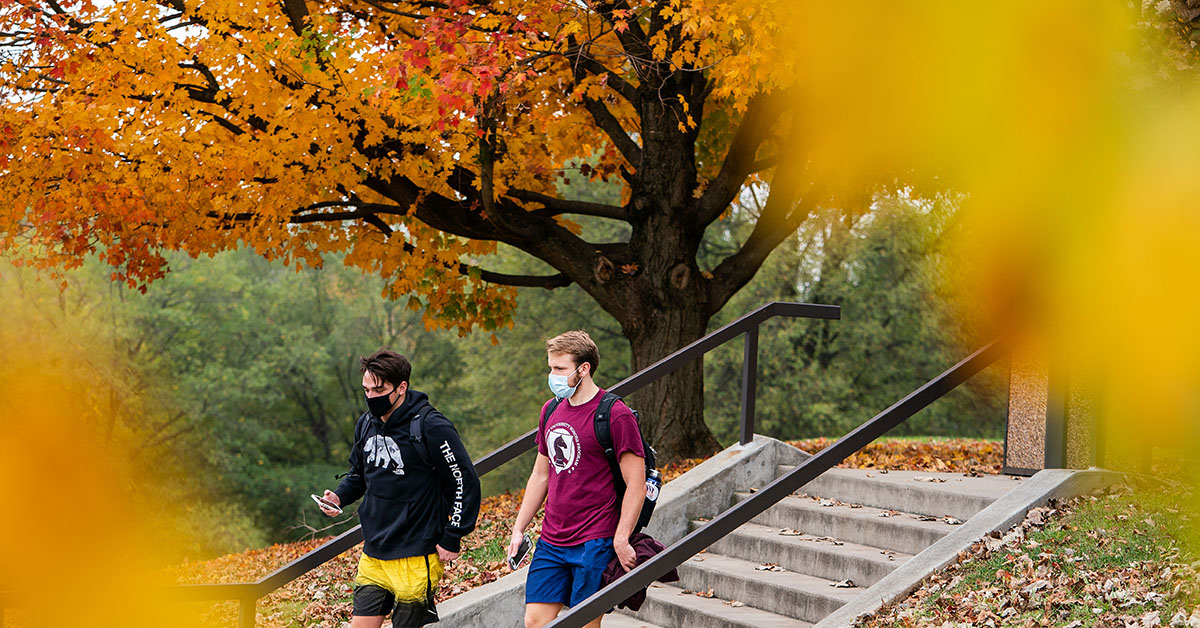 Students walking on campus with masks on