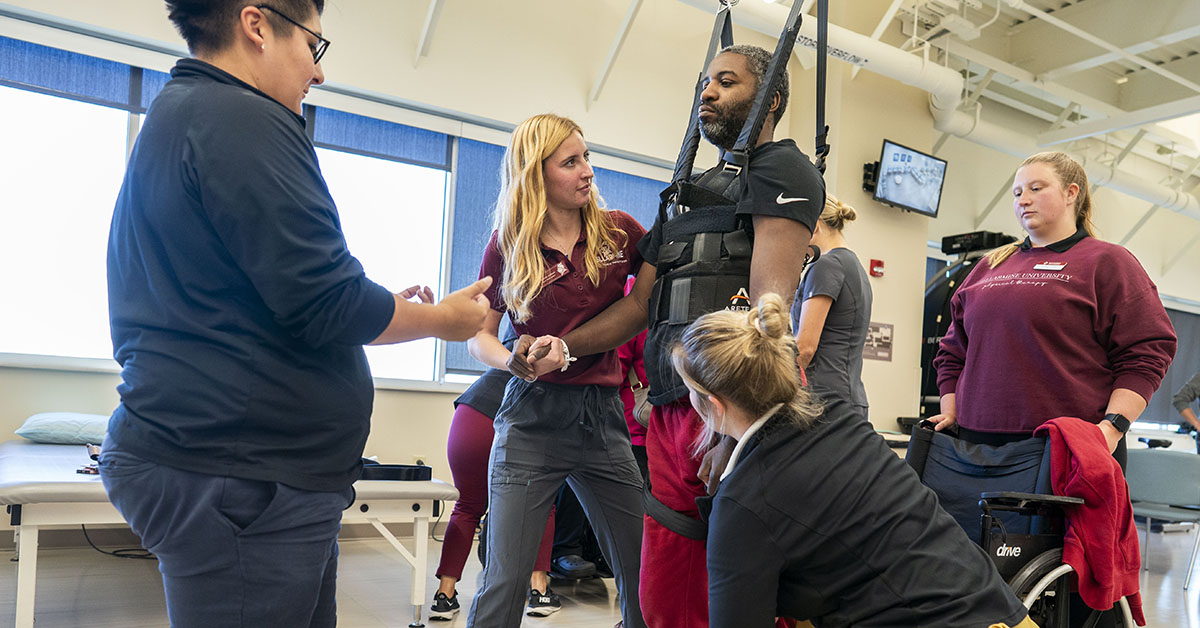 physical therapy students practice on patients