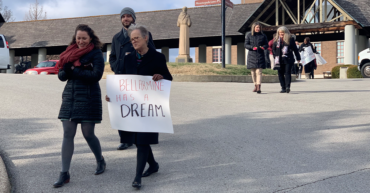 Bellarmine faculty, staff, and administrators honoring Dr. Martin Luther King Jr. walking and holding signs