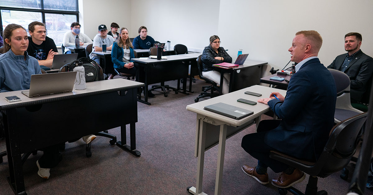 a group of people sitting in a classroom