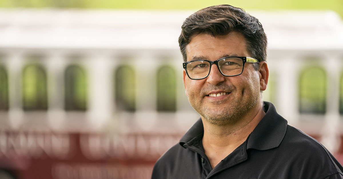A student standing by the Bellarmine trolley 