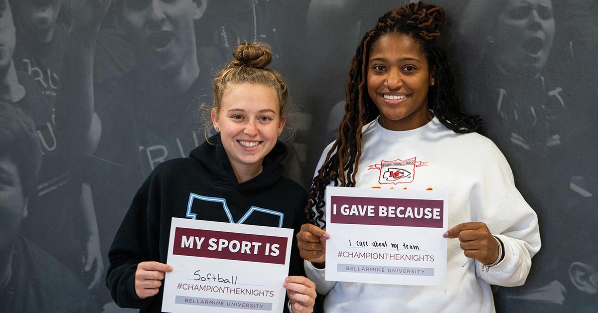 Two students standing and smiling 