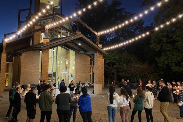 students gather for a candlelight vigil outside the chapel