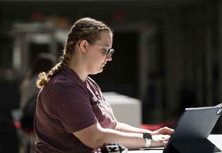 Student typing on a laptop