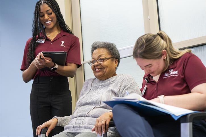 Bellarmine University students work with an elderly community member.