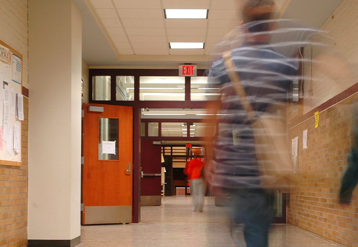 principal walking down hallway with student