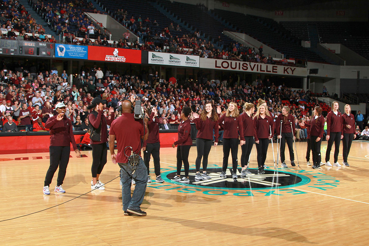 Women's basketball team on Freedom Hall court